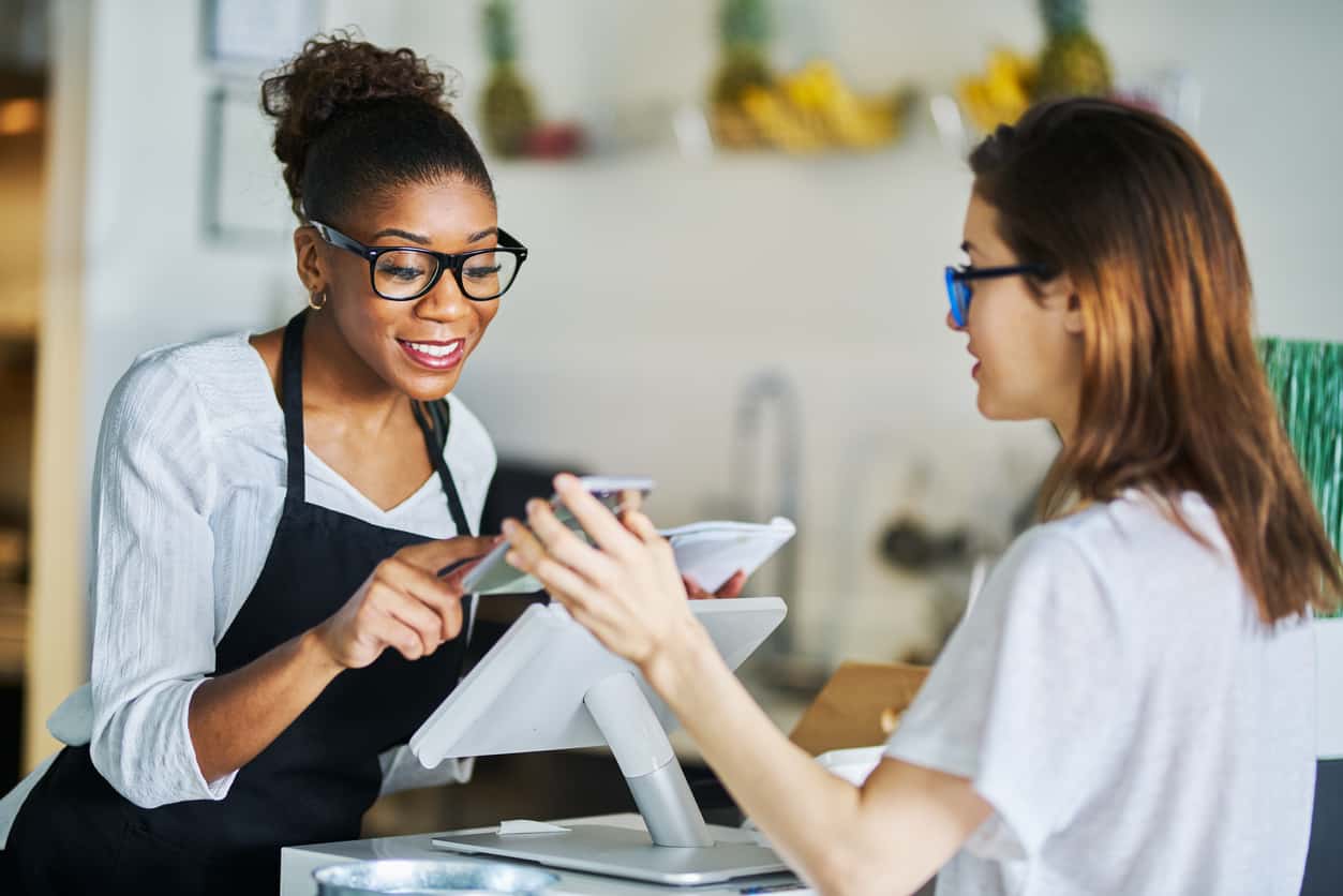 customer using online coupon from smartphone app at restaurant during the day